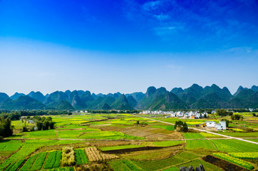 Countryside and mountain scenery with blue sky background 