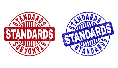 Grunge STANDARDS round stamp seals isolated on a white background. Round seals with grunge texture in red and blue colors. Vector rubber overlay of STANDARDS caption inside circle form with stripes.