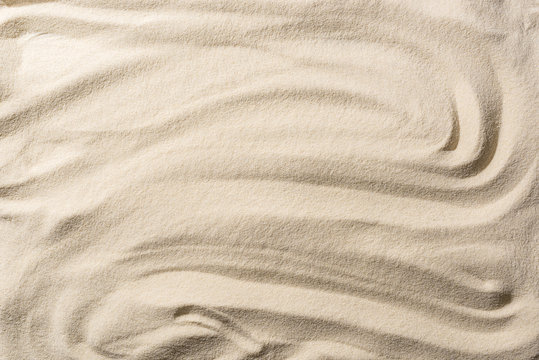 top view of textured sandy beige background with smooth waves