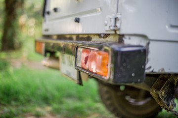 Close-up background view of car taillights (jeeps) that are used to transport cargo in rubber plantations, oil palm, for two lighting while braking.