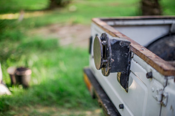 Close-up background view of the ear tug on the back of the car (jeep) that is used to transport wool in the rubber plantation, oil palm, to facilitate transportation.