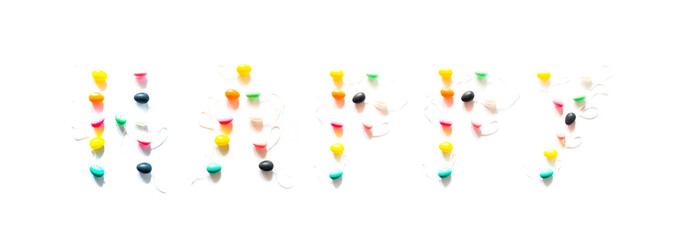 Colorful small eggs on a white background arranged to form the text happy  , holiday easter concept