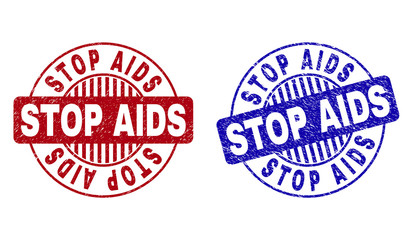 Grunge STOP AIDS round stamp seals isolated on a white background. Round seals with grunge texture in red and blue colors. Vector rubber overlay of STOP AIDS caption inside circle form with stripes.