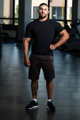 Fototapeta na wymiar Healthy Man Posing In Black T-shirt