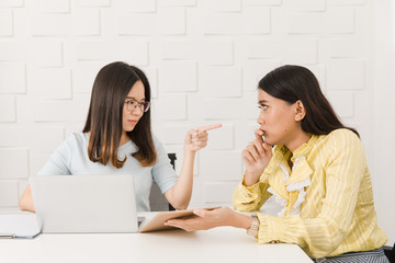 Two Asian architect ladies at office