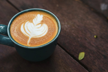 hot latte coffee drink put on wooden table in the morning day