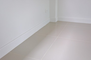 empty room interior, white mortar wall and clean tile floor in a new house