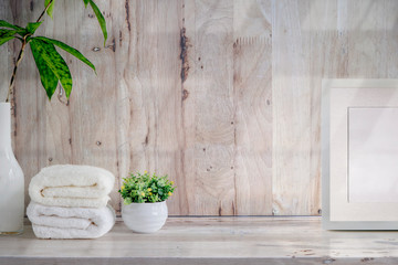 Mockup bath towels on wooden table with copy space.