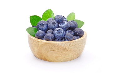 Blueberry : fresh blueberries with green leaves in wooden bowl isolated on white background.