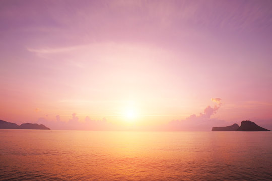 Sunrise horizon cool sea background on horizon tropical sandy beach; relaxing outdoors vacation
