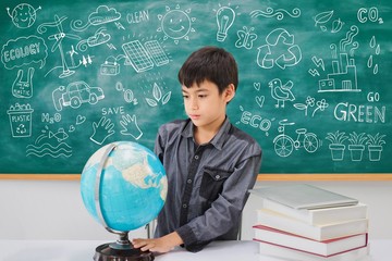 Asian school boy thinking and searching with globe and book on table with blackboard and ecology...
