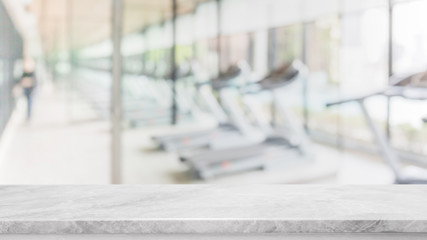 Empty white marble stone table top on blurred with bokeh Exercise room,fitnees and gym interior background - can be used for display or montage your products - 260911326