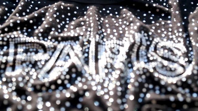 Shiny letters Paris on a black background
