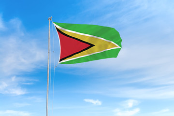 Guyana flag over blue sky background