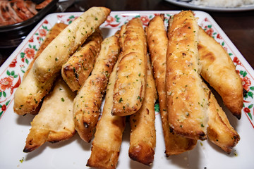 Garlic bread sticks on a serving plate