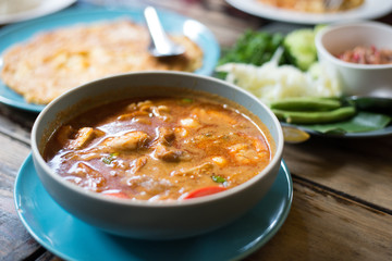 Soft focus tom yam kung thai food on vintage table