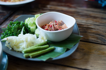 soft focus thai food nam prik goong siab on wood table
