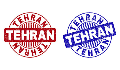 Grunge TEHRAN round stamp seals isolated on a white background. Round seals with grunge texture in red and blue colors. Vector rubber imitation of TEHRAN title inside circle form with stripes.