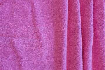 Fototapeta na wymiar Top view of Pink Towel texture. Pink Towel Fabric Texture Background. Close-up. Pink natural cotton towel background. Space for text. Hygiene, fabric, laundry,spa and textile concept.
