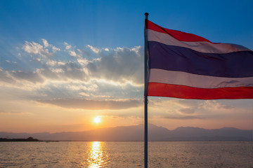 Thailand flag flying with sunset sky