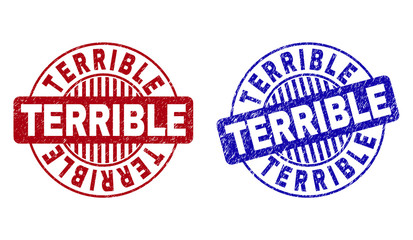 Grunge TERRIBLE round stamp seals isolated on a white background. Round seals with grunge texture in red and blue colors. Vector rubber imprint of TERRIBLE label inside circle form with stripes.
