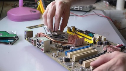 electronic technician assemble motherboard. PC repair. Install processor