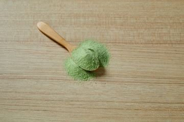 Wooden spoon with powdered matcha green tea