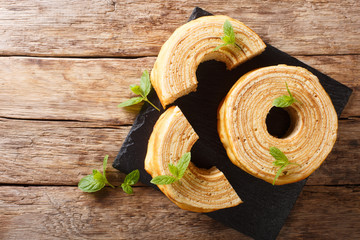 Baumkuchen, translated as tree cake, is a many-layered sponge cake baked on a rotating cylinder...