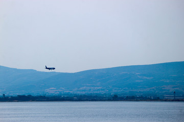 Plane landing to Thessaloniki airport Makedonia at clear weather above the mediterranean sea