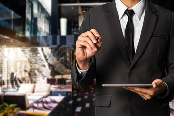 businessman using a tablet, smartphone during sunrise overlay with cityscape image. The concept of modern life, business, city life and internet of things with VR icon in morning light. 