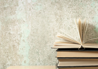 Open book, hardback books on wooden table. Education background. Back to school. Copy space for text.