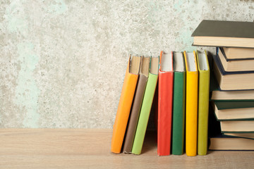 Stack of colorful books on the wooden table. Education background.Back to school. Copy space for text.