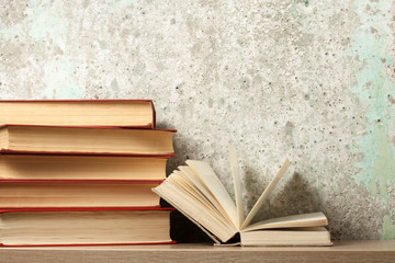 Open book, hardback books on wooden table. Education background. Back to school. Copy space for text.