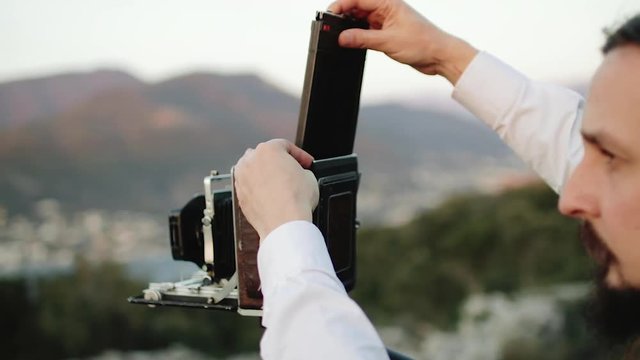 Photographer professional takes photos on a large format camera