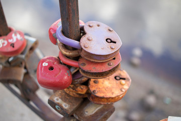 locks in the form of hearts hanging on the fence