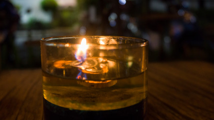 candles in a glass on a wooden table