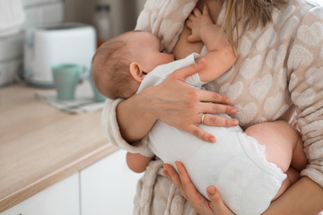 mom breast-feeds baby