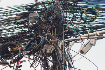 Crazy messy chaos wires cables on Electric poles. - obrazy, fototapety, plakaty