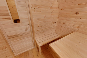 Fototapeta na wymiar interior of wooden bath in the form of a barrel. Rural mobile bath