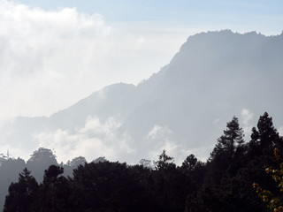 Clouds passing through mountain ranges and forest