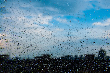 blue Texture Raindrops on window glass for rain, photo, blurred background, drizzle