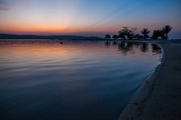 Sunset over beach and Lake Victoria, Uganda, Africa