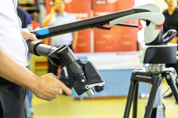 Man holding head of high technology and modern automatic 3d laser scan for measuring or reverse engineering industrial manufacture