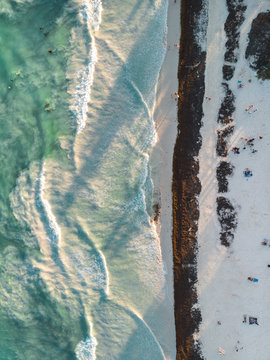 Foamy waves near sandy shore