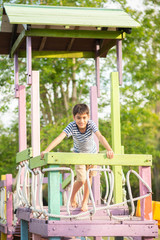 Obraz premium Little boy playing in the playground outdoor