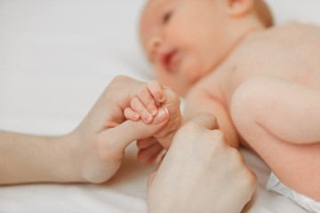 Newborn children's hand in mother hand. Mom and her Child. Happy Family concept.baby holds mother's finger.
