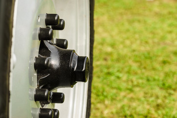 Close up of detailed black bolts on wheel