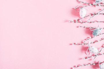 Easter pink composition. Easter eggs and willow branch on pastel pink background. Flat lay, top view, copy space
