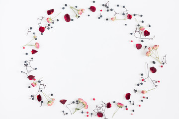 Fototapeta na wymiar Autumn creative, modern composition. Frame made of berries, dry roses, petals on white background. Autumn, fall elegant concept. Flat lay, top view, copy space 