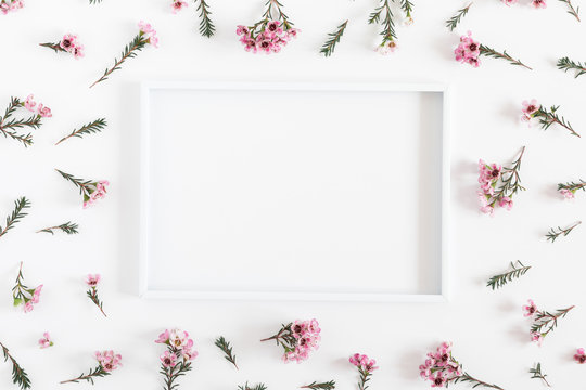 Beautiful flowers composition. Blank frame for text, pink flowers on white background. Valentines Day, Easter, Birthday, Happy Women's Day, Mother's day. Flat lay, top view, copy space